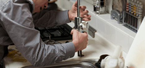 Man trying to fix kitchen sink