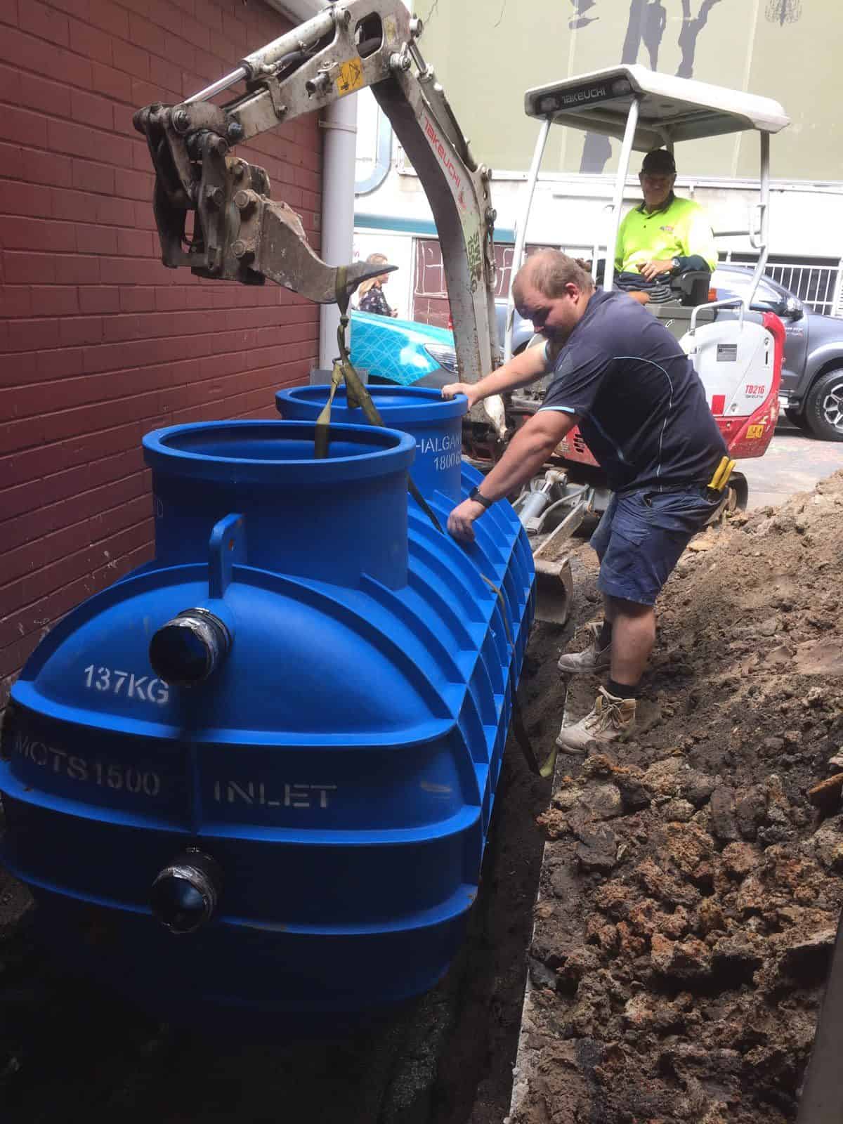 Emu team maintaining commercial grease traps
