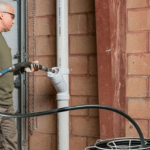 Man using robot cutter to clean pipes