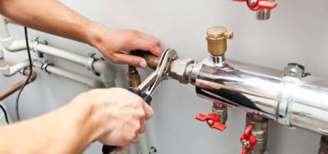 Industrial plumber working on installation